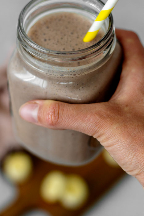 Smoothie zum Frühstück. Ein Rezept mit Joghurt, gefrorener Banane, Haferflocken, Leinsamen und Kakao.
